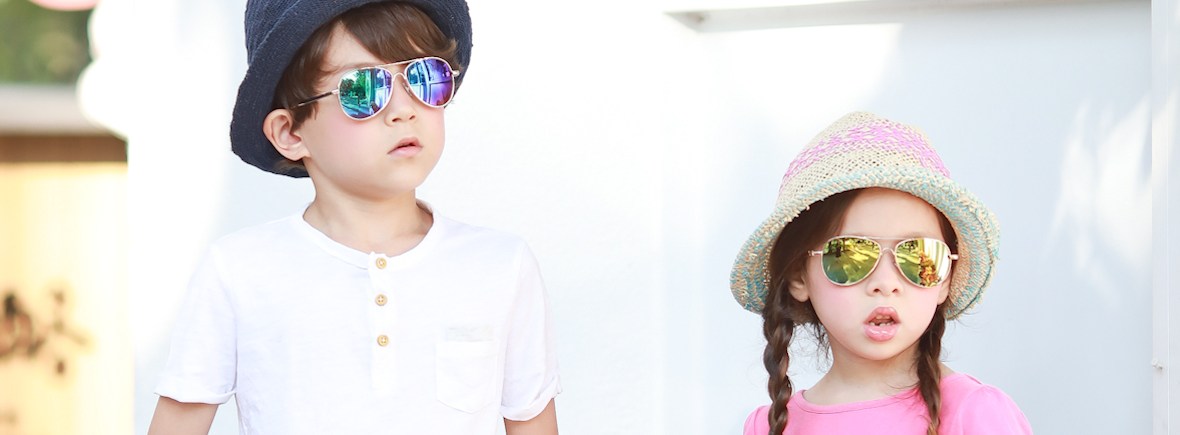 Boy and girl wearing Kids I, IE68038 Aviator in silver and gold frame with Revo mirror lens.